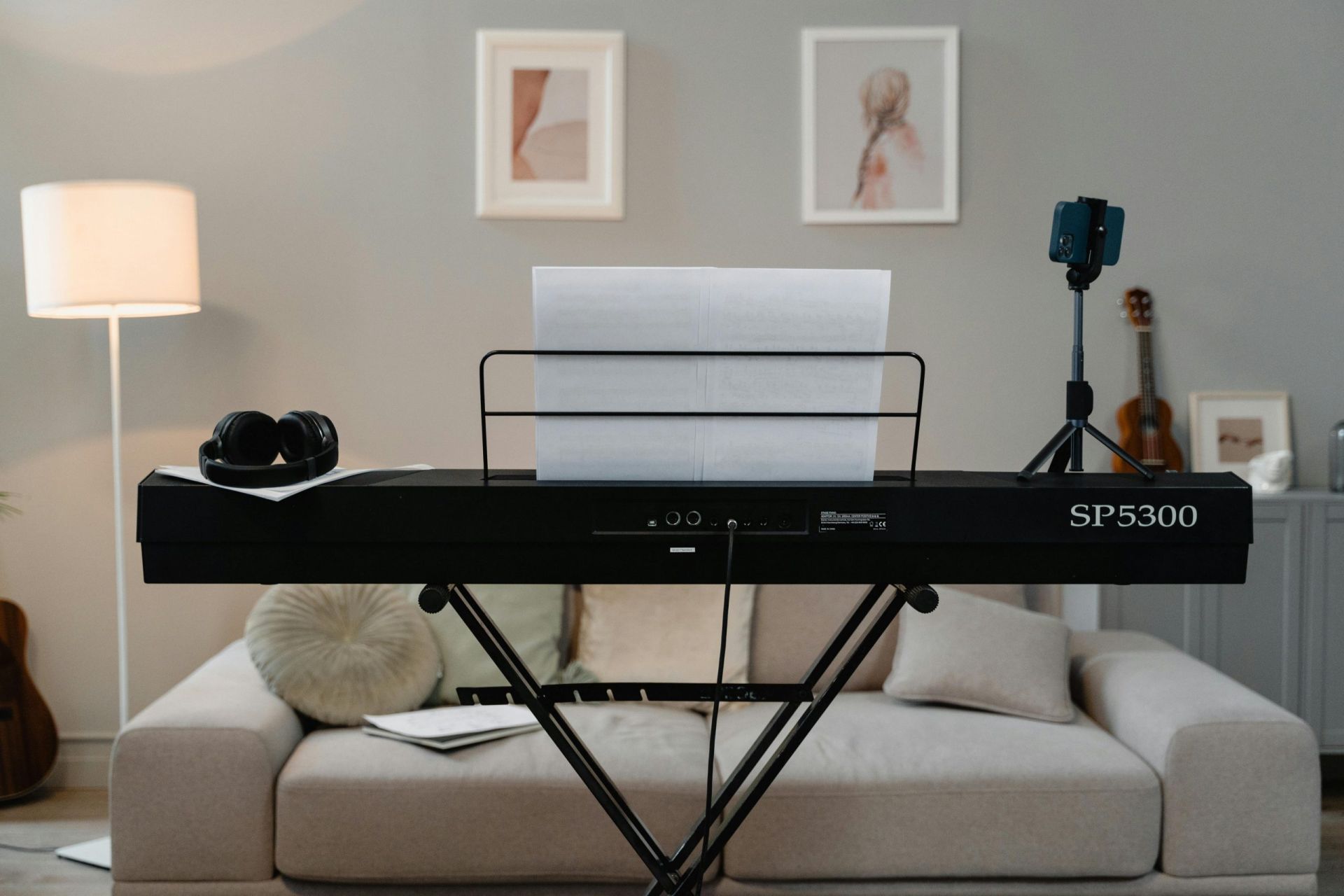 Home piano practice room with digital piano, headphones, and cozy decor