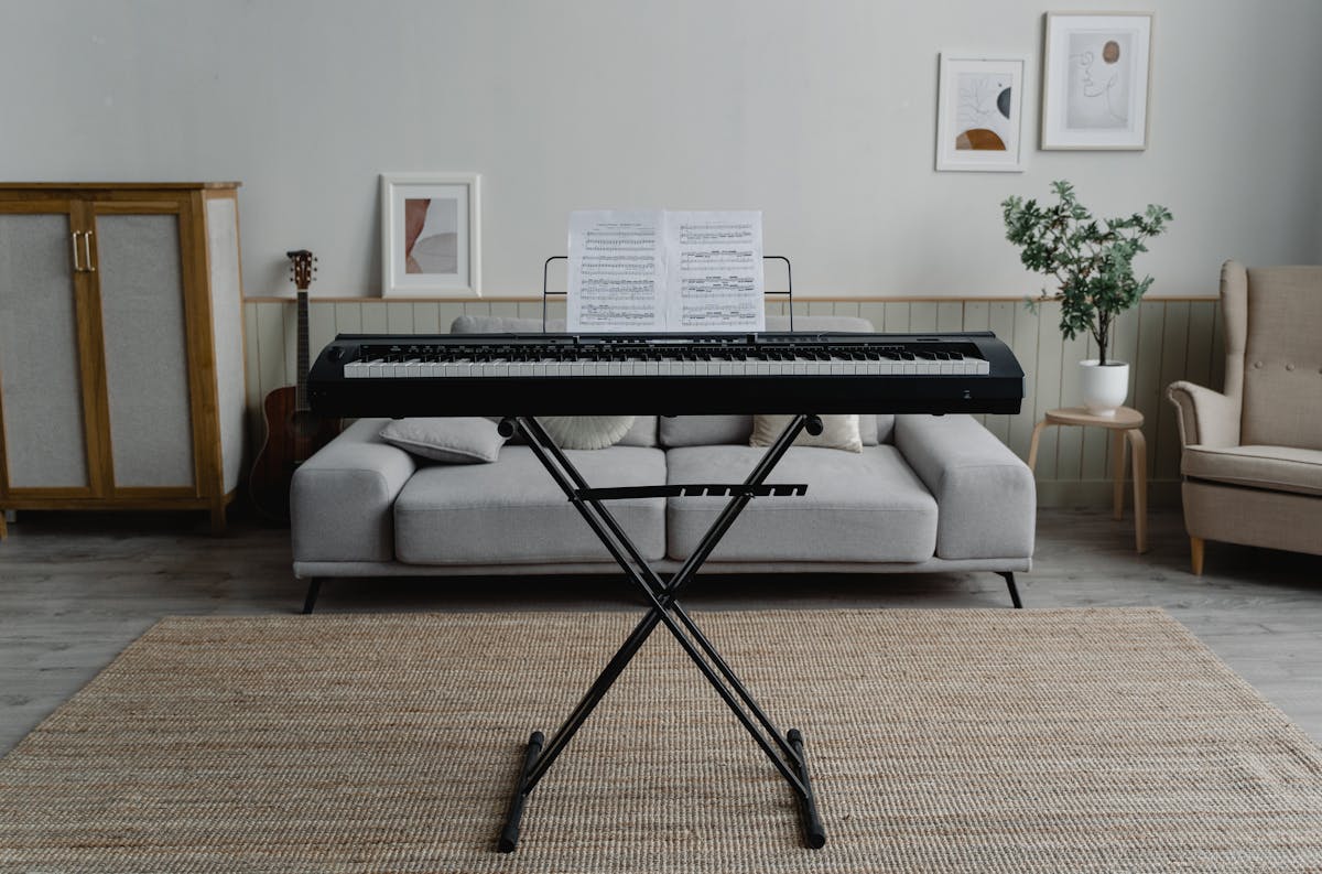 Digital piano on a stand in a bright modern living room - representing the home studio trend driving piano market growth in 2026